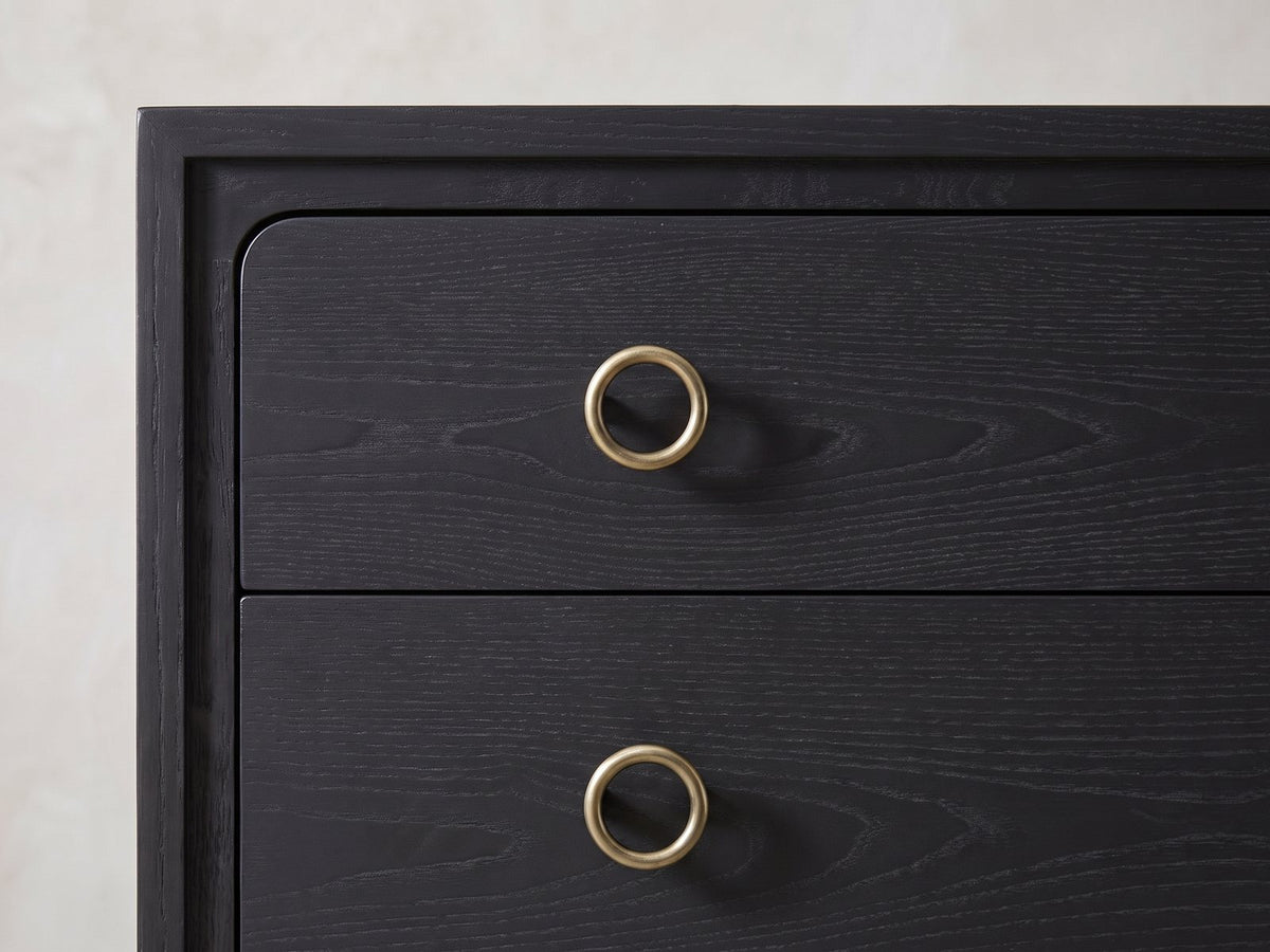 Close-up of the Cologna 40-Inch Peppercorn 5-Drawer Chest: an antique-brass ring pull on a peppercorn elm drawer front