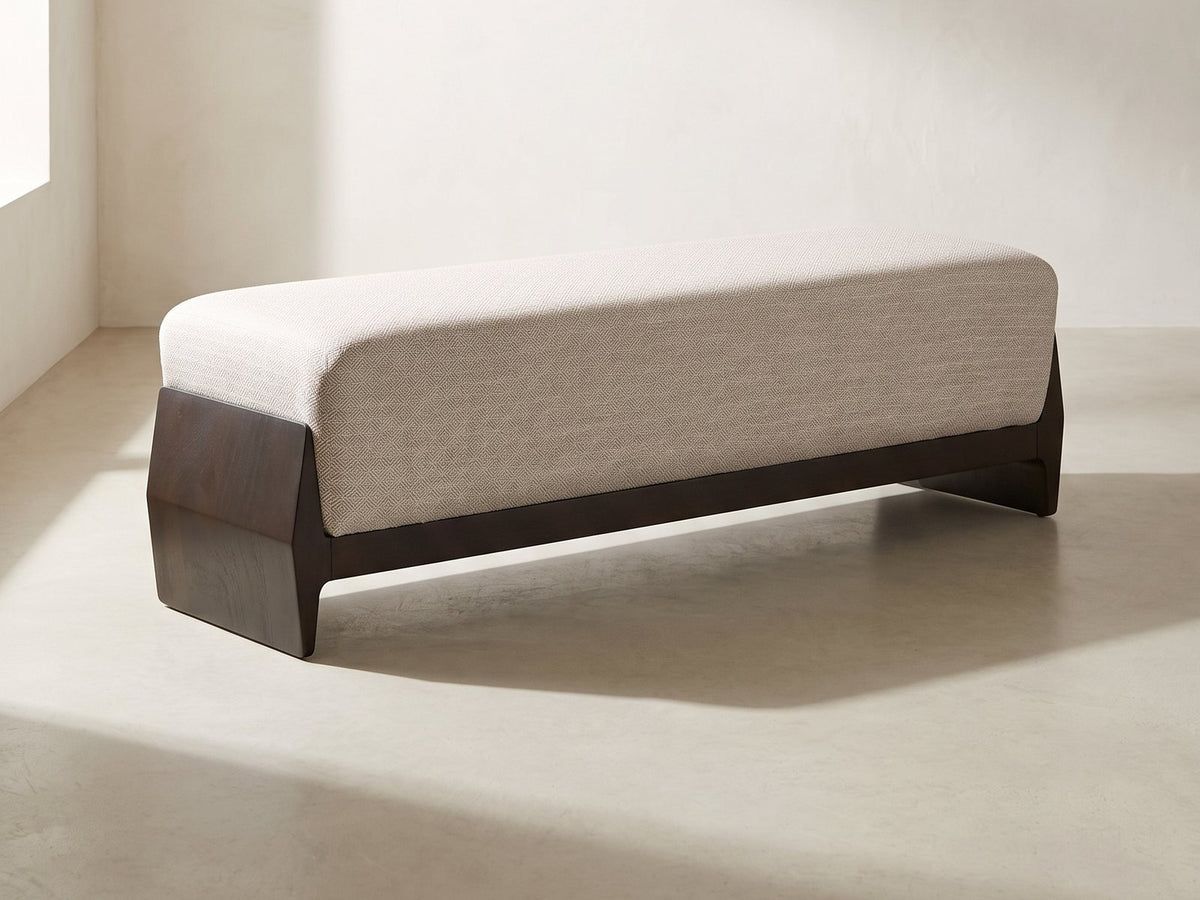 Como Wood Cradle Bench in oatmeal against a plaster wall in morning light