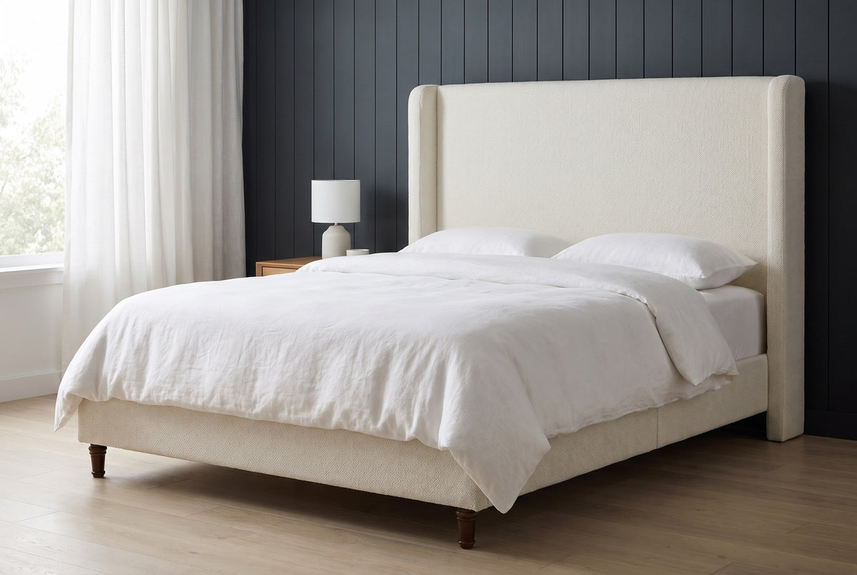 Conversano bed against dark charcoal-blue vertical panelling in a Seattle apartment bedroom with a pale oak floor