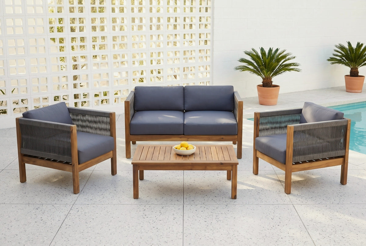 Corleone acacia conversation set on a terrazzo pool terrace in front of a white breeze-block screen wall, with potted sago palms (bowl of lemons not included)