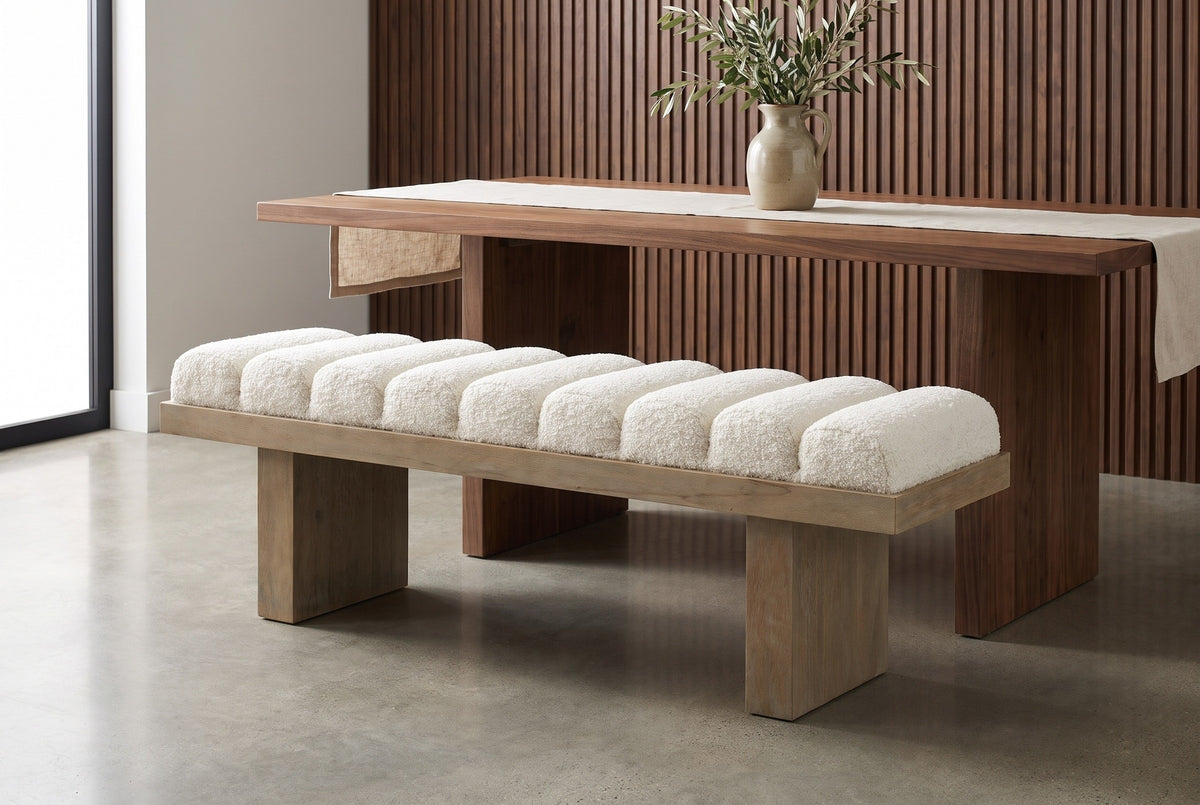 Deruta bench pulled up to a long walnut dining table in a Los Angeles dining room with fluted walnut wall panels and a pale polished concrete floor (table not included)