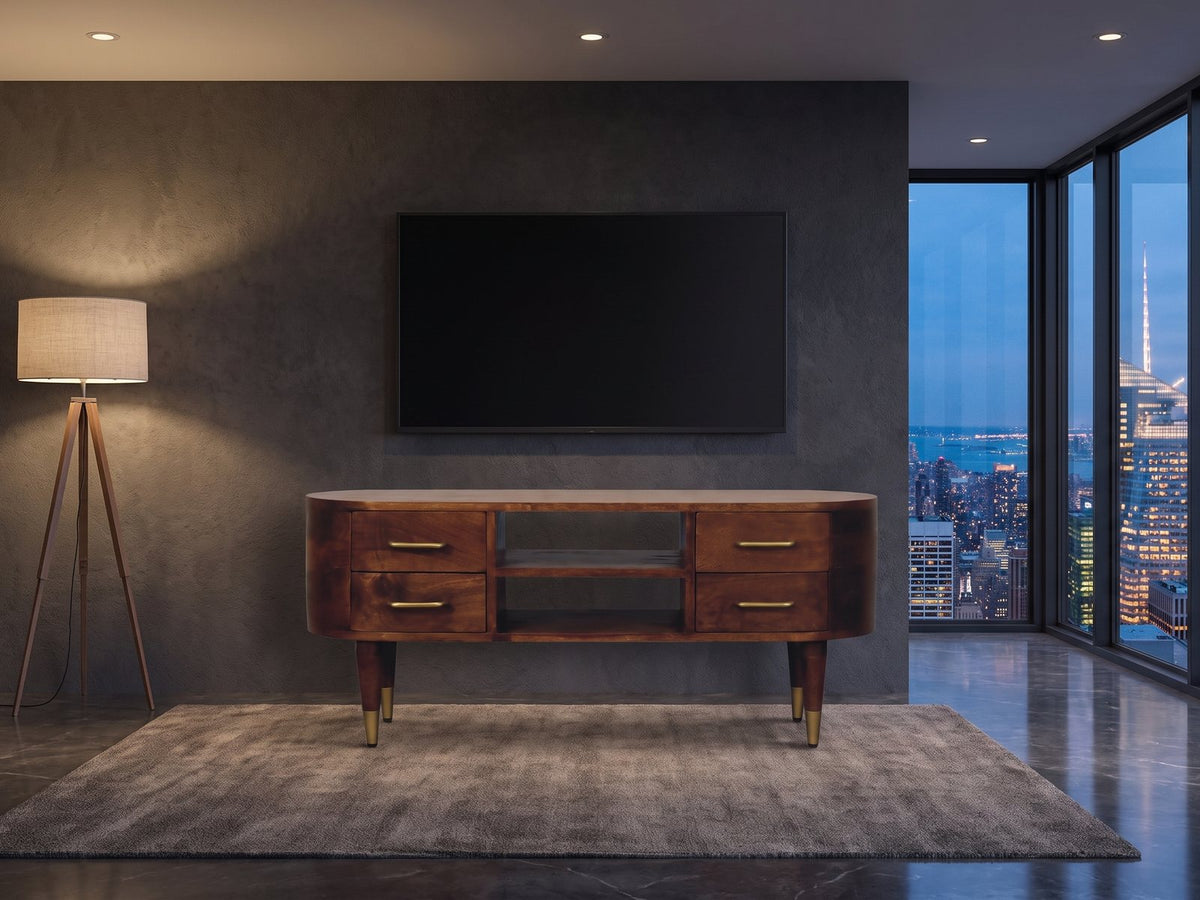 Erice Curved Mango Media Console under a wall-mounted screen in a city penthouse at blue hour