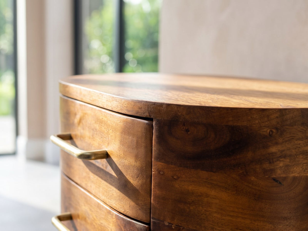 Close-up of the Erice Curved Mango Media Console: the rounded corner of the mango top and the curved drawer fronts below it
