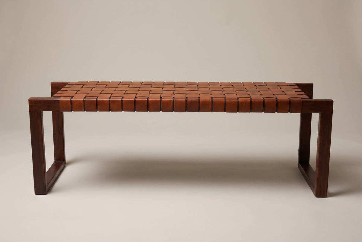 The Fasano bench, front view of the long side on a light studio backdrop: the row of leather strap loops and an end frame at each end
