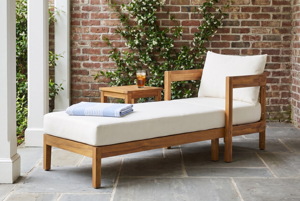 Favignana acacia chaise in a Charleston garden loggia with an old red-brick wall, star jasmine and a bluestone floor (side table not included)