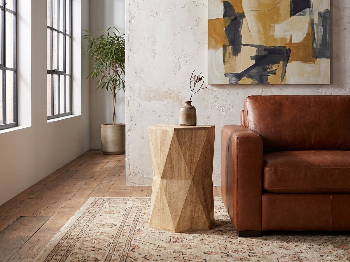 Gallicano Mango Faceted Hexagon Side Table beside a leather sofa in an industrial loft