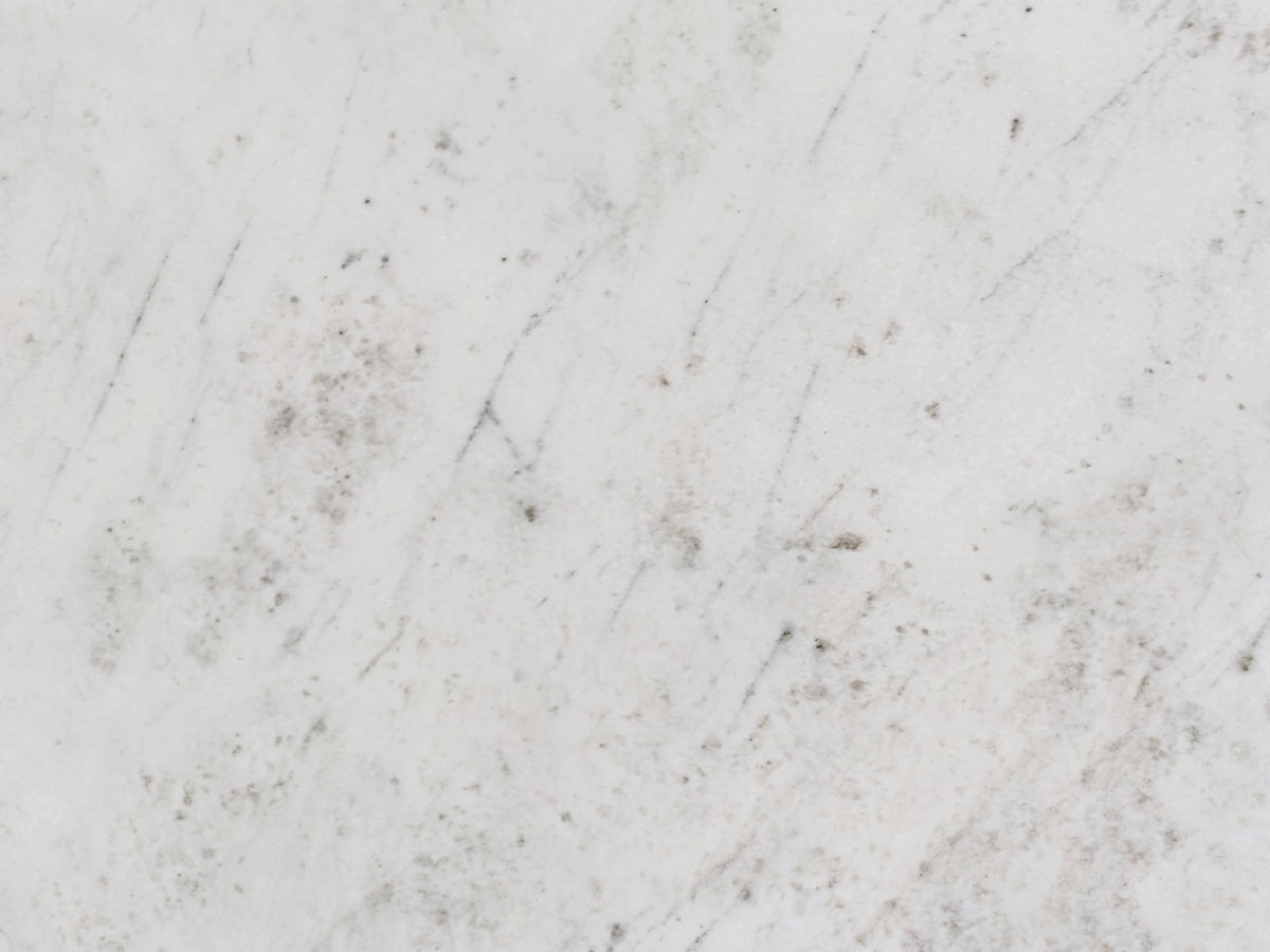 Close-up of the Genazzano White Marble Tapered Pedestal Side Table: the soft white marble of the top