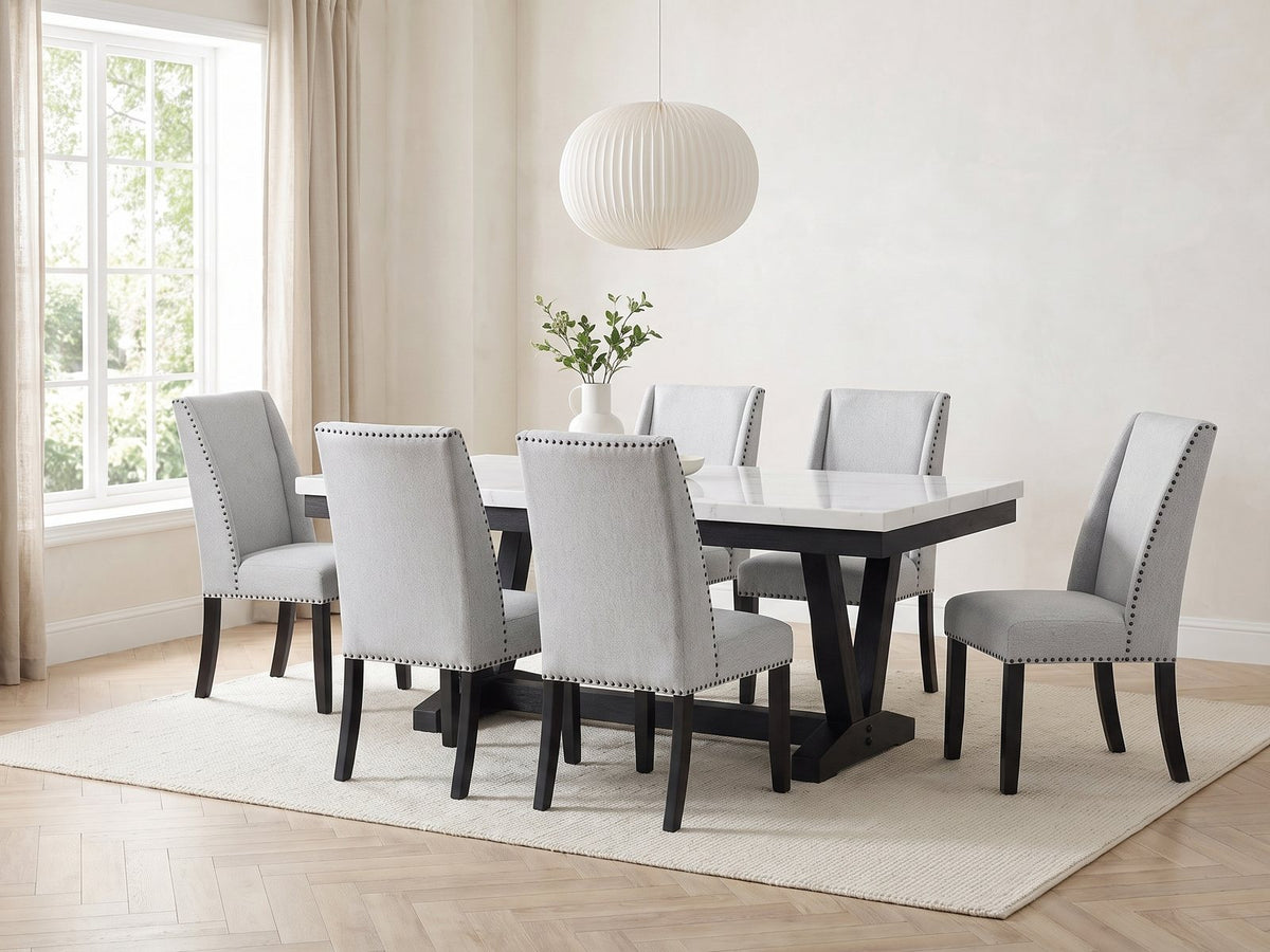Gerace 72-Inch White Marble V-Trestle Dining Set with 6 Chairs in a bright plaster dining room with linen curtains