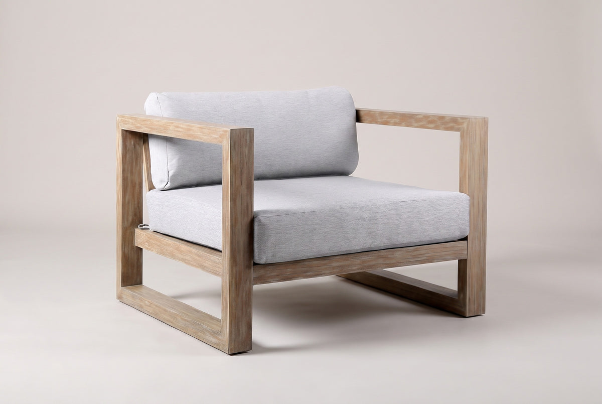 The Giardini eucalyptus lounge chair with light gray cushions, three-quarter front view on a light studio backdrop