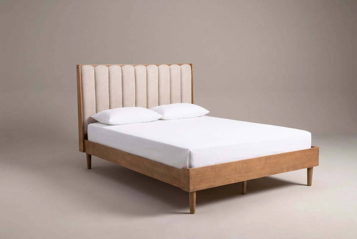 The Giulianova bed in wheat pine with an oatmeal scalloped headboard, a white mattress and pillows (not included), three-quarter view on a light studio backdrop