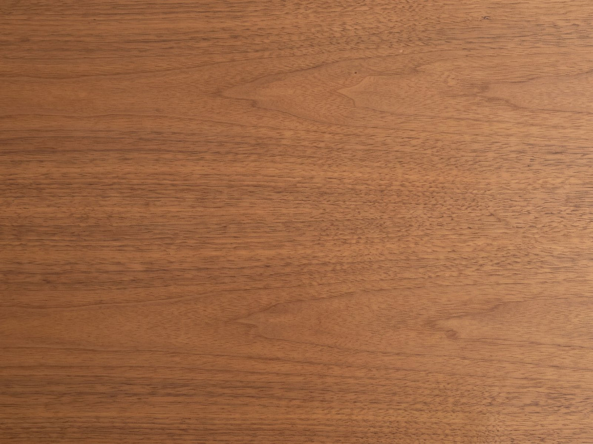 Close-up of the Grado 34-Inch Warm Walnut 5-Drawer Chest: the warm walnut veneer of the top