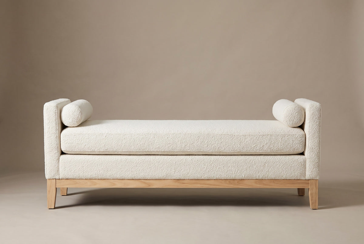 The Gualdo bench in ivory boucle, straight front view on a light studio backdrop