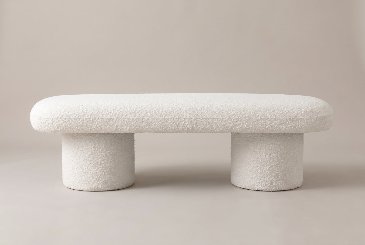 The Gubbio bench in ivory boucle, front view on a light studio backdrop