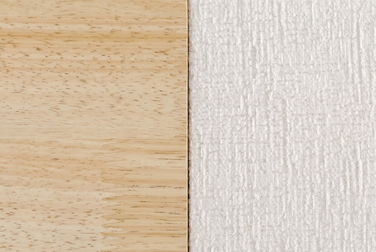 Close-up of the Isernia bed where natural rubberwood meets the cream textured upholstery