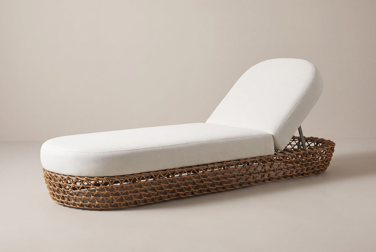 The Isnello woven chaise lounger with a wheat beige cushion, three-quarter view from the foot end on a light studio backdrop