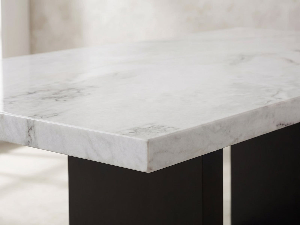 Close-up of the Itri 70-Inch White Marble Double Pedestal Dining Set with 6 Chairs: the polished white marble top and one black slab pedestal