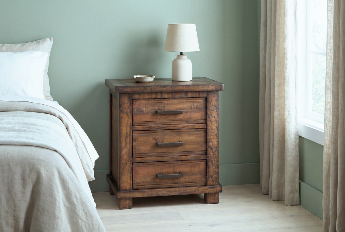 Ittiri reclaimed pine nightstand with a ceramic lamp against a sage green plaster wall in a Charleston bedroom with linen curtains and a pale oak floor