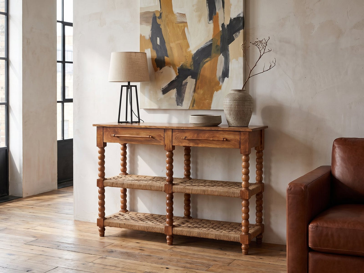 Laterza Mango Wood Spindle Console Table against a plaster wall in an industrial loft