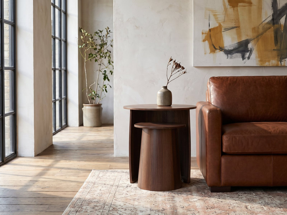 Laurenzana Dark Brown Mango Nesting Side Tables, Set of 2 beside a leather sofa in an industrial loft
