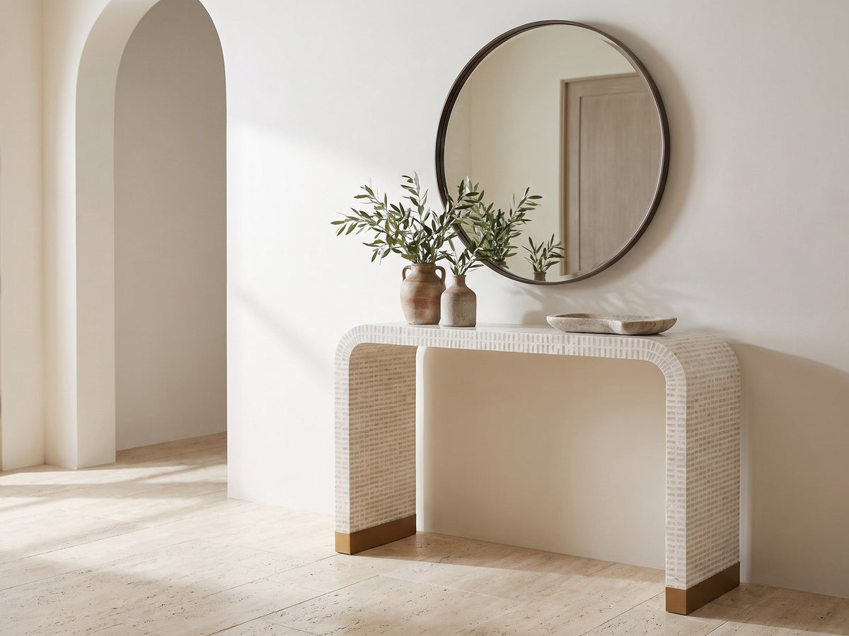 Leporano Capiz Shell Waterfall Console Table under a round mirror in a travertine entryway