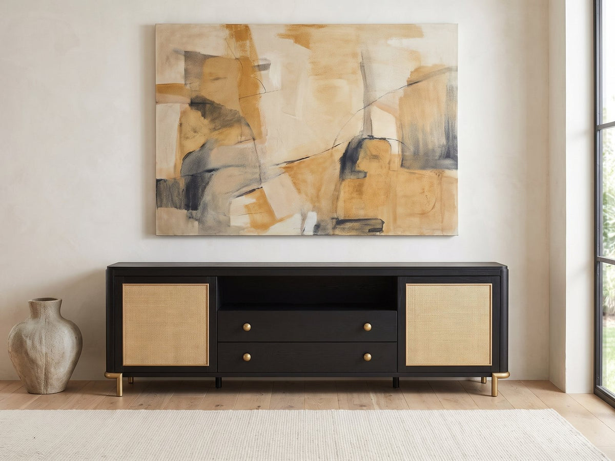 Levanto 80-Inch Black Ash and Rattan Media Console under a large abstract painting in a bright living room