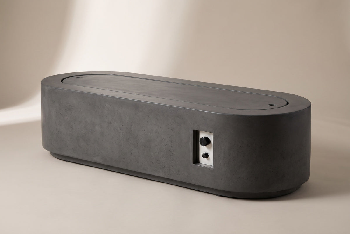 The Licata fire pit table with the matching lid on, a low dark grey concrete coffee table with rounded ends