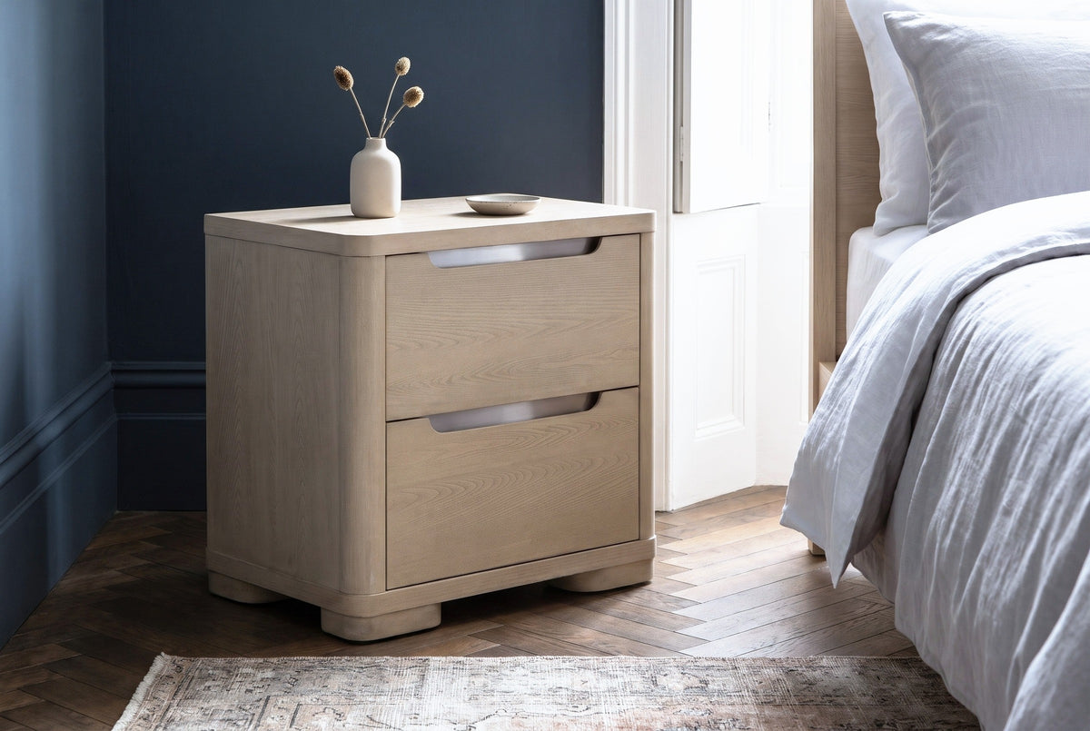 Mandas light elm nightstand against an inky slate blue wall in a Brooklyn brownstone bedroom with a herringbone floor