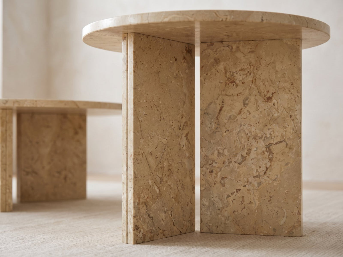 Close-up of the Mantova Gold Beige Marble Nesting Coffee Tables, Set of 2: the two gold beige marble slabs set in a T under the side table's top