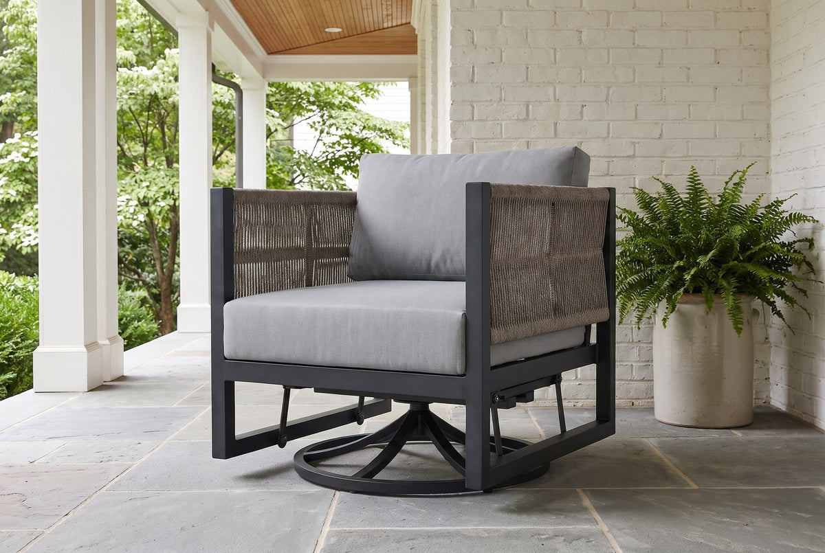 The Marsala swivel glider lounge chair on an Atlanta back porch with a whitewashed brick wall, a bluestone floor, a cedar ceiling and a fern