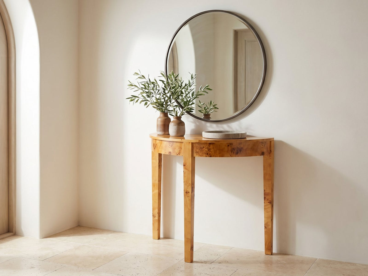 Massafra Burl Half-Moon Console Table under a round mirror in a travertine entryway