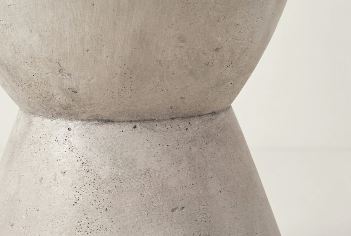 Close-up of the light grey lightweight concrete on the Mazzaro side table, with fine pores and the seam at the waist