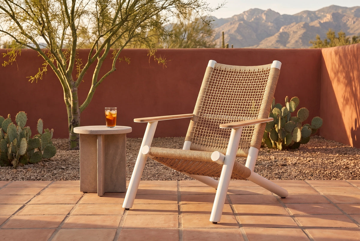 Militello Adirondack lounge chair on a saltillo tile patio in Tucson, a terracotta adobe wall, prickly pear and the Catalina mountains behind (side table not included)