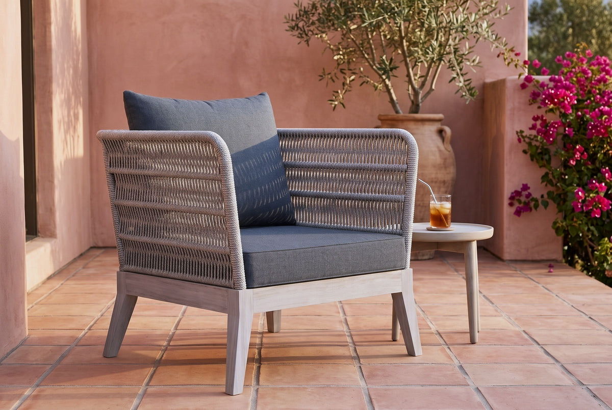 Mistretta rope lounge chair on a terracotta-tiled terrace in Ojai, a pink lime-plaster wall, an olive tree and bougainvillea behind (side table not included)