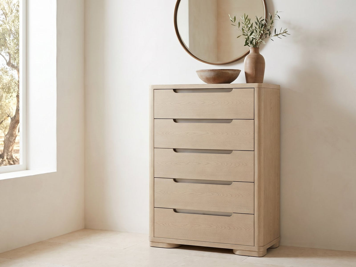Monselice 38-Inch Light Elm 5-Drawer Chest under a round bronze mirror in a villa bedroom