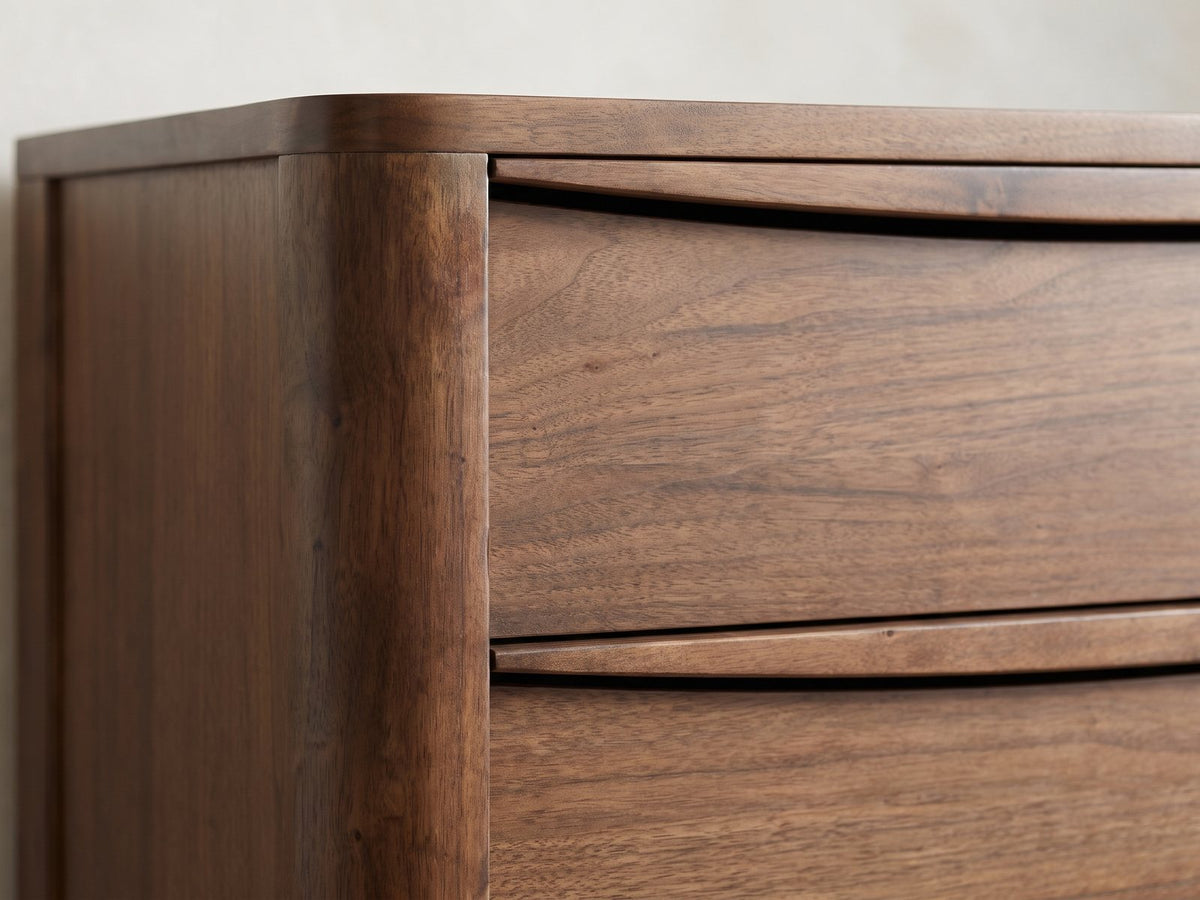 Close-up of the Montagnana 40-Inch Walnut 5-Drawer Chest: the carved arched finger pulls along the tops of the walnut drawers