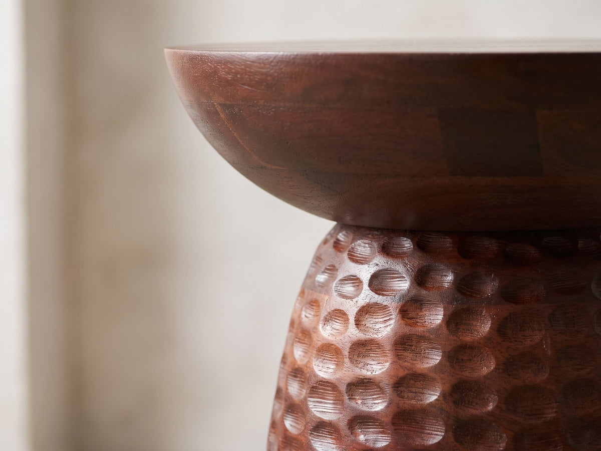 Close-up of the Montalbano Carved Mango Pedestal Side Table: the smooth bowl top over the hand-carved mango pedestal