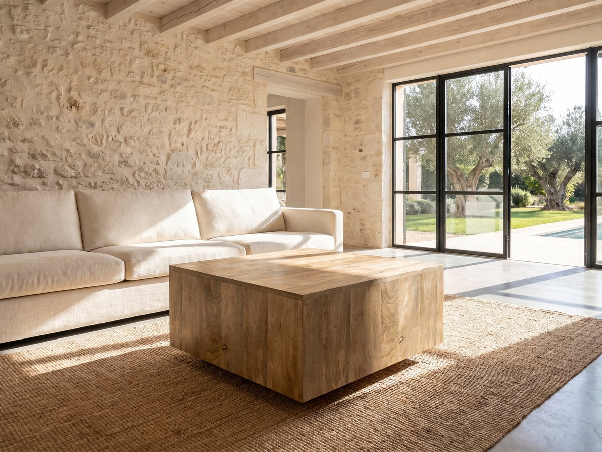 Montecatini Square Mango Coffee Table on a jute rug in front of a linen sofa in a poolside villa