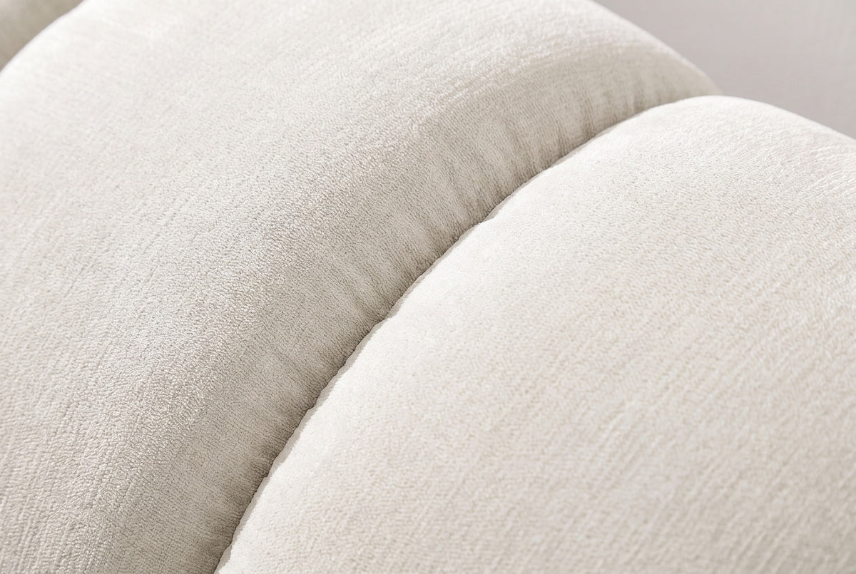 Close-up of the beige chenille on the Montenerodomo bed: a deep seam between two plump padded channels