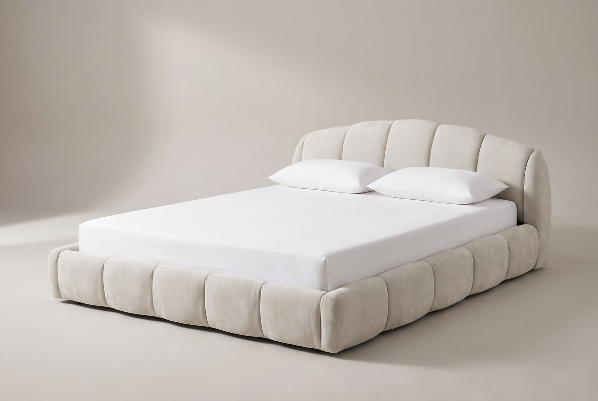The Montenerodomo floor bed in beige chenille with a white mattress and pillows (not included), three-quarter view on a light studio backdrop
