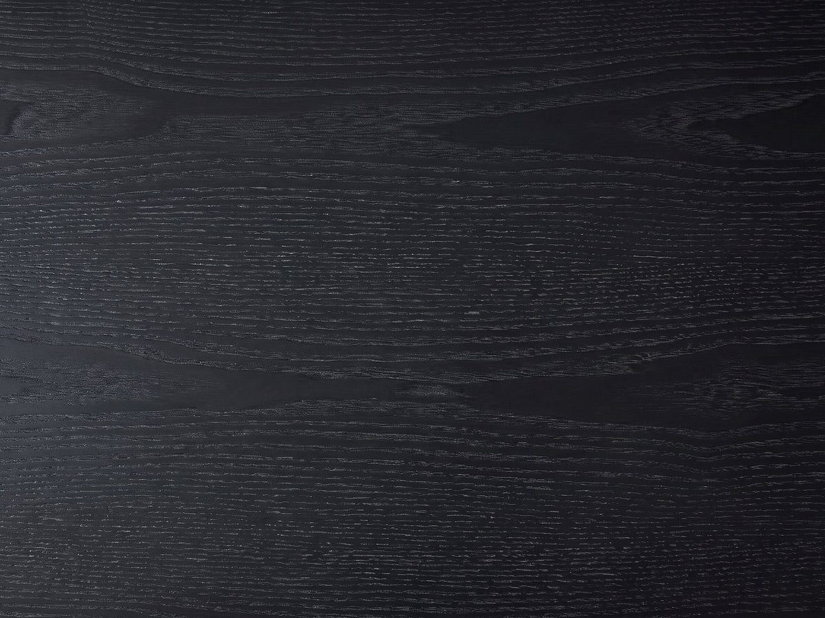 Close-up of the Monterosso Black Wood Veneer Fluted Oval Console Table: the open grain of the black top