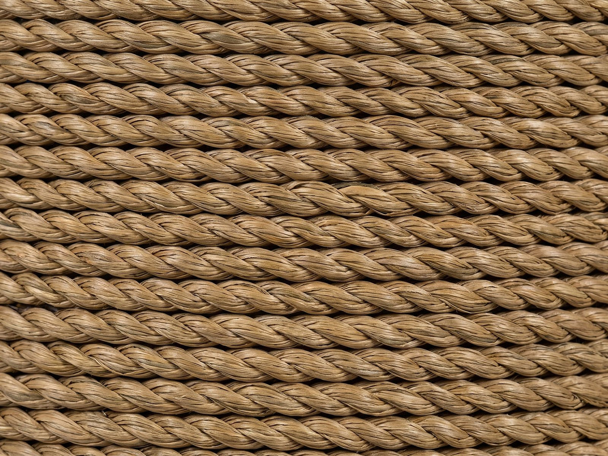 Close-up of the Montescaglioso Woven Seagrass Drum Side Table: the twisted seagrass rope wrapped around the side