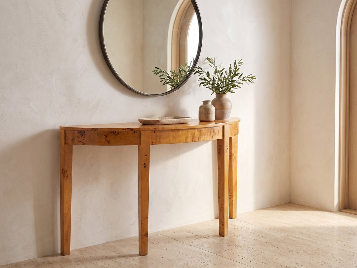 Mottola Mappa Burl Half-Moon Console Table under a round mirror in a travertine entryway