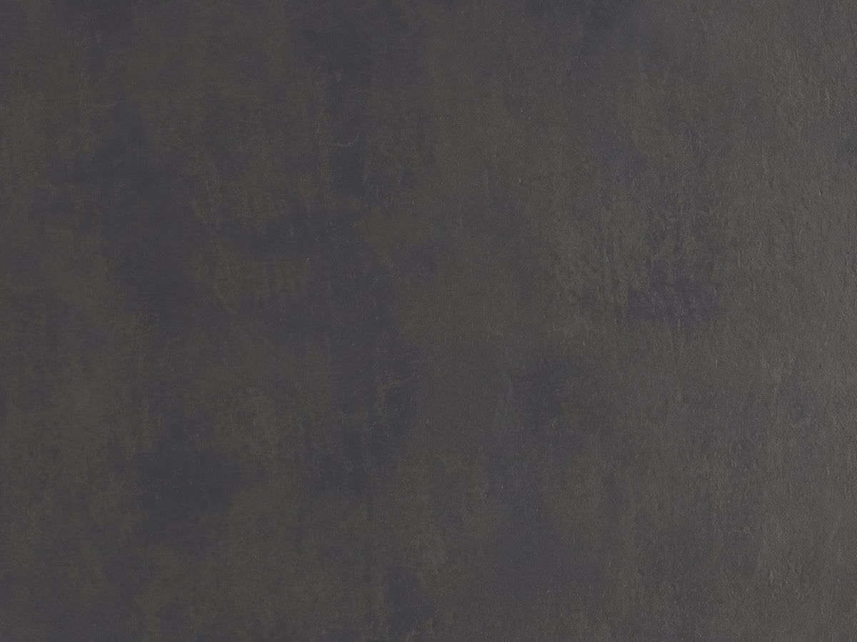 Close-up of the Navelli Graphite Cast Aluminum Pedestal Side Table: the hand-finished graphite cast aluminum of the top