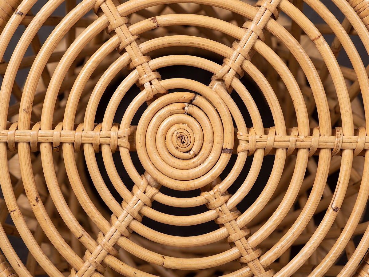 Close-up of the Neviano Natural Rattan Hourglass Side Table: the concentric rattan rings of the open top