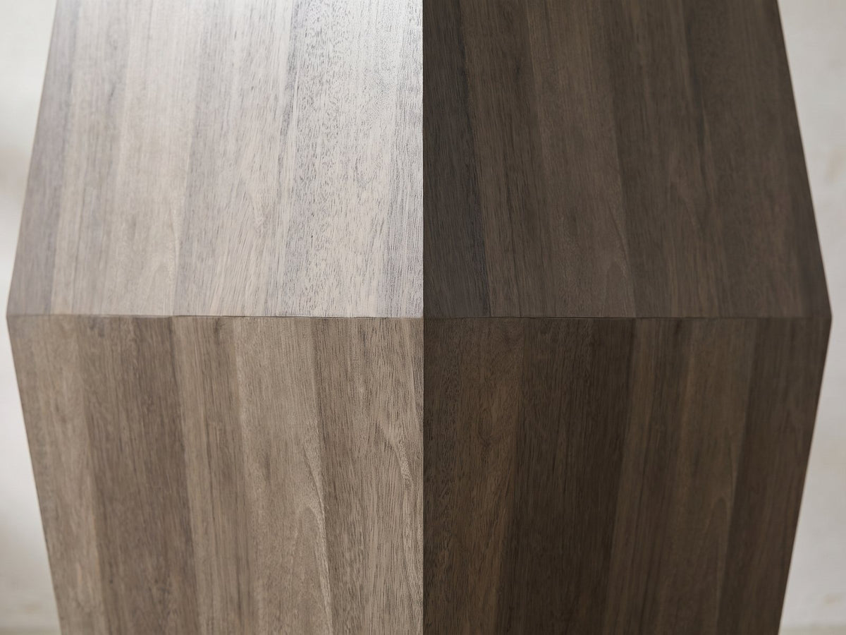 Close-up of the Nicotera Ash Grey Mango Faceted Side Table: the flat faces meeting at the crease at mid-height