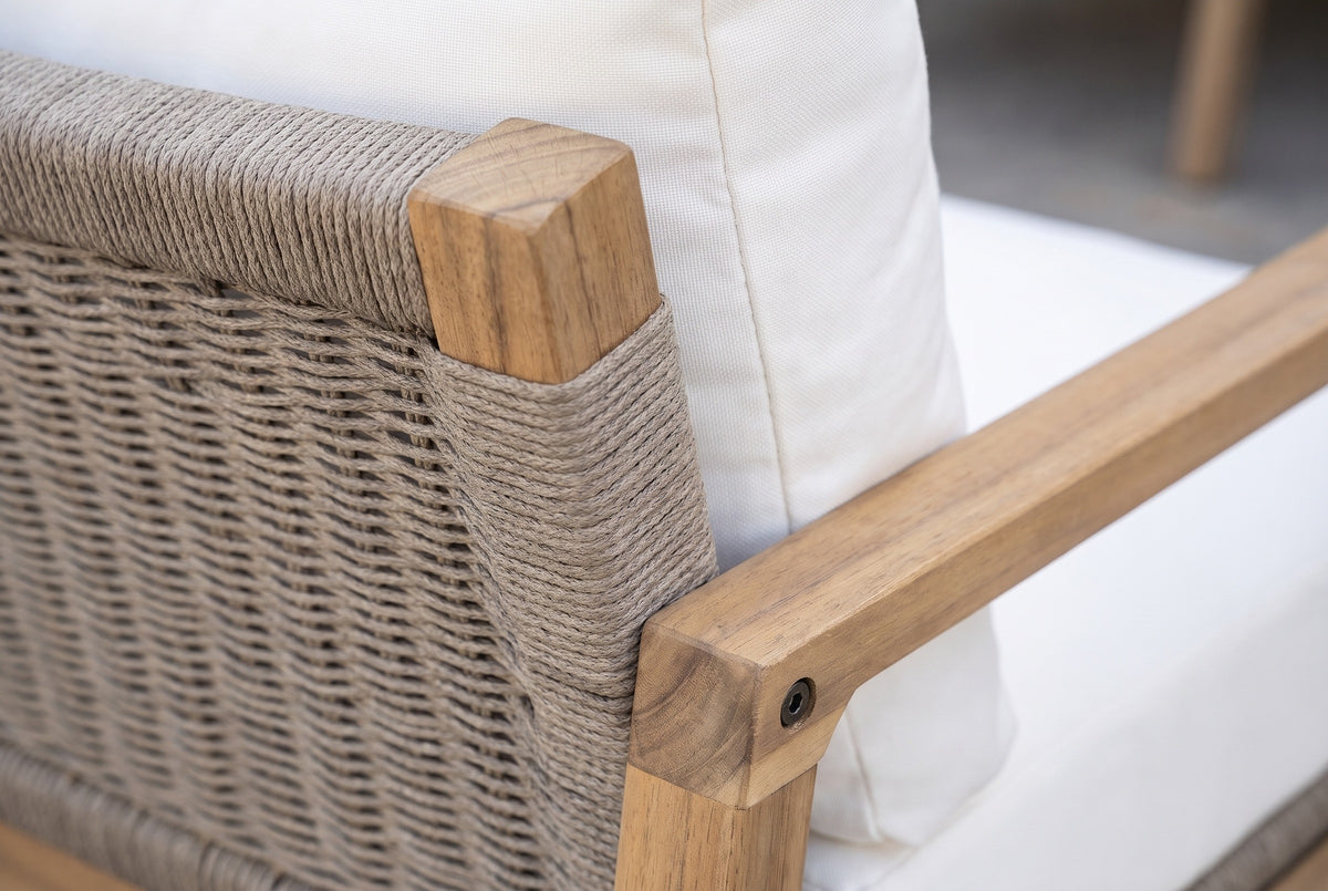Close-up of the Niscemi chair: woven taupe rope wrapped round an acacia back post with an oiled teak finish, the white cushion behind