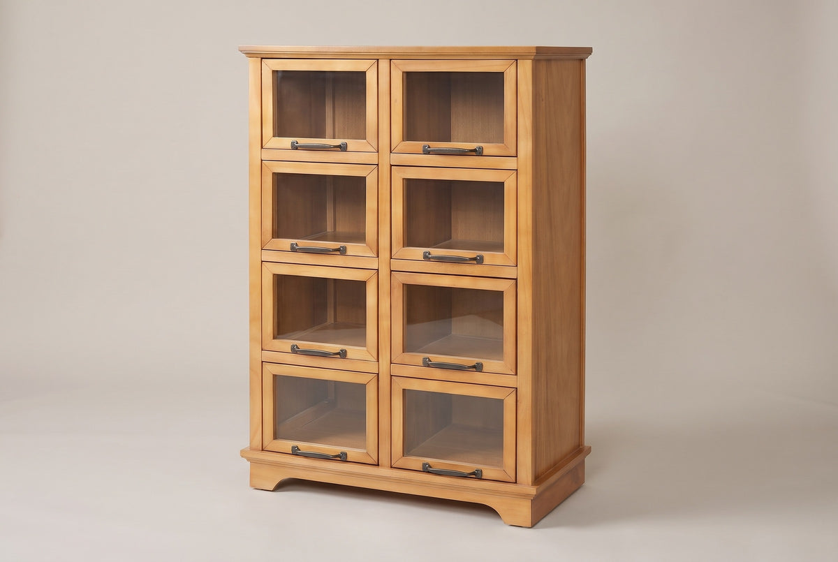 The Noci pine display cabinet in honey pine with eight glass doors and bronze-finish pulls, three-quarter view on a light studio backdrop