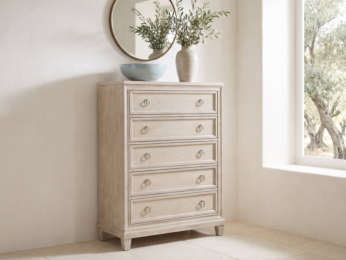 Oderzo 36-Inch Washed Oak 5-Drawer Chest under a round bronze mirror in a villa bedroom
