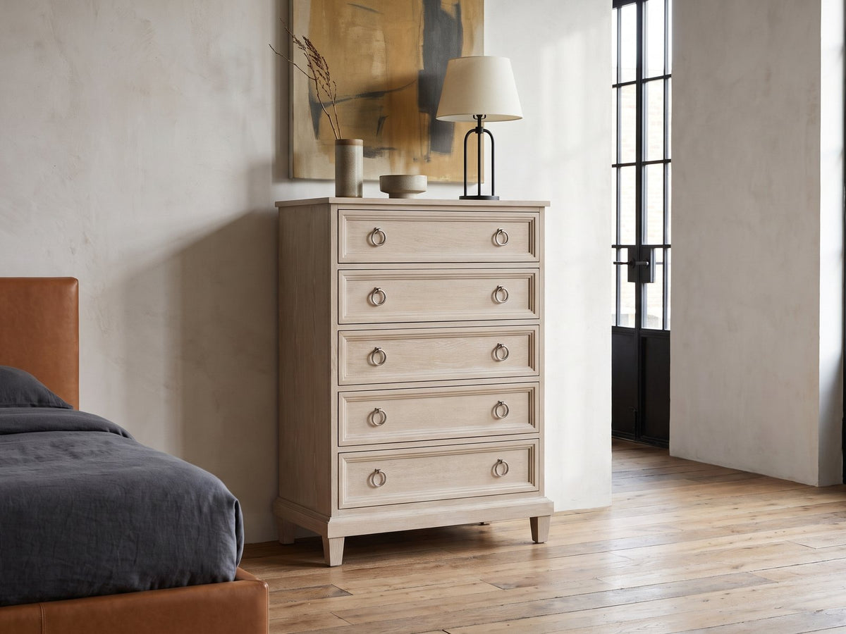 Oderzo 36-Inch Washed Oak 5-Drawer Chest against a plaster wall in an industrial loft bedroom