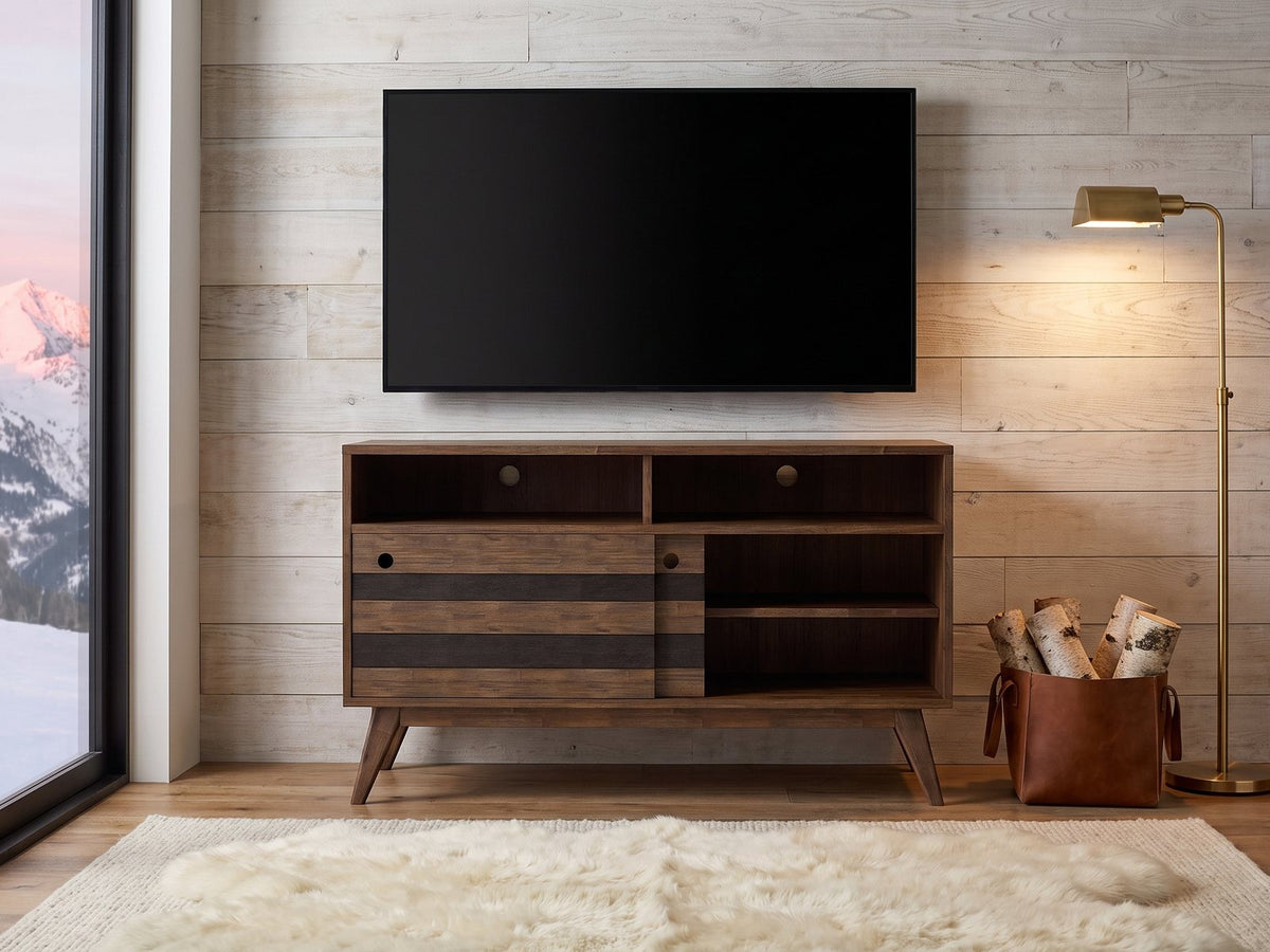 Offida Two-Tone Acacia Media Console under a wall-mounted screen in an alpine chalet at dusk
